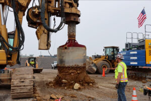 An auger removes soil from the drilled pier shaft